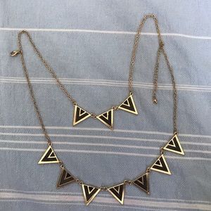 A long gold necklace with triangle charms
